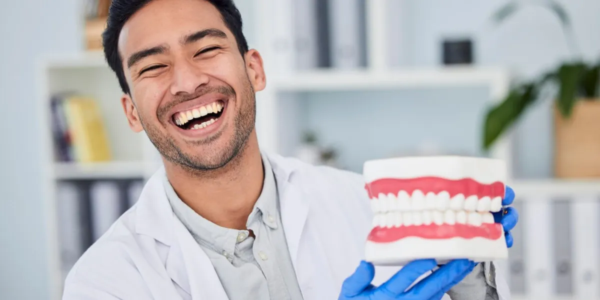 happy asian man, dentist and teeth for dental care, veneers or healthcare at hospital portrait of male person or medical expert with big smile in happiness for oral, mouth and gum health at clinic