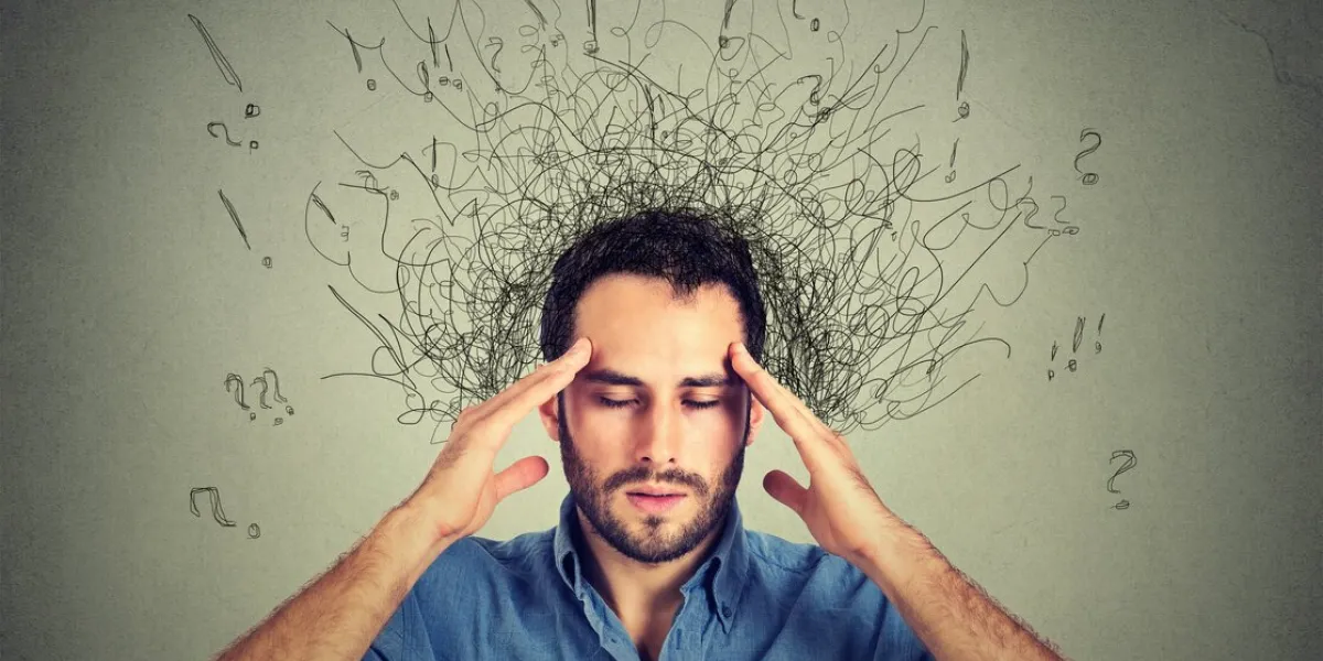 closeup sad young man with worried stressed face expression and brain melting into lines question marks obsessive compulsive, adhd, anxiety disorders