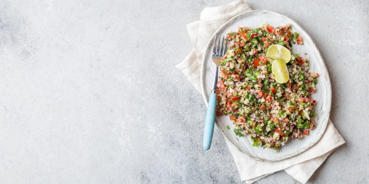 quinoa quinua salad with tomatoes and herbs in white bowl