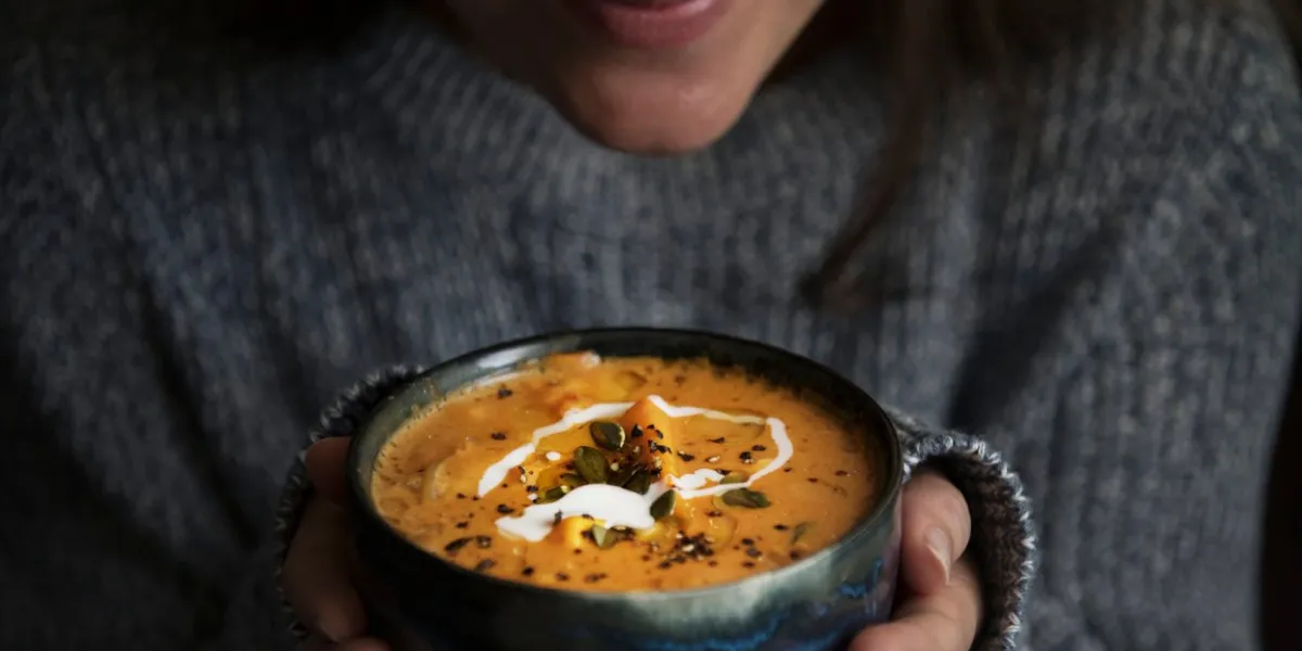 woman holding a bowl of soup food photography recipe idea