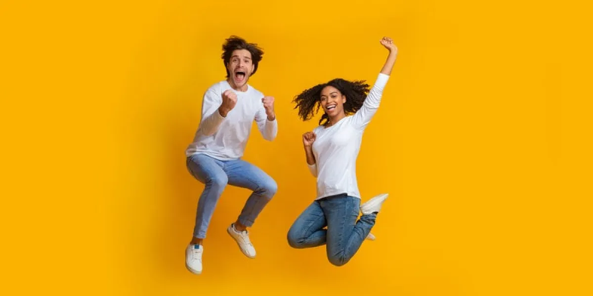 unbelievable sales overjoyed multiracial couple jumping in the air and celebrating success, can't believe their luck, exclaiming with joy, panorama