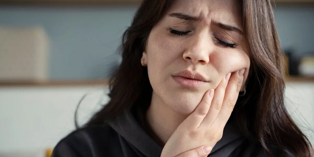 woman suffering toothache at home