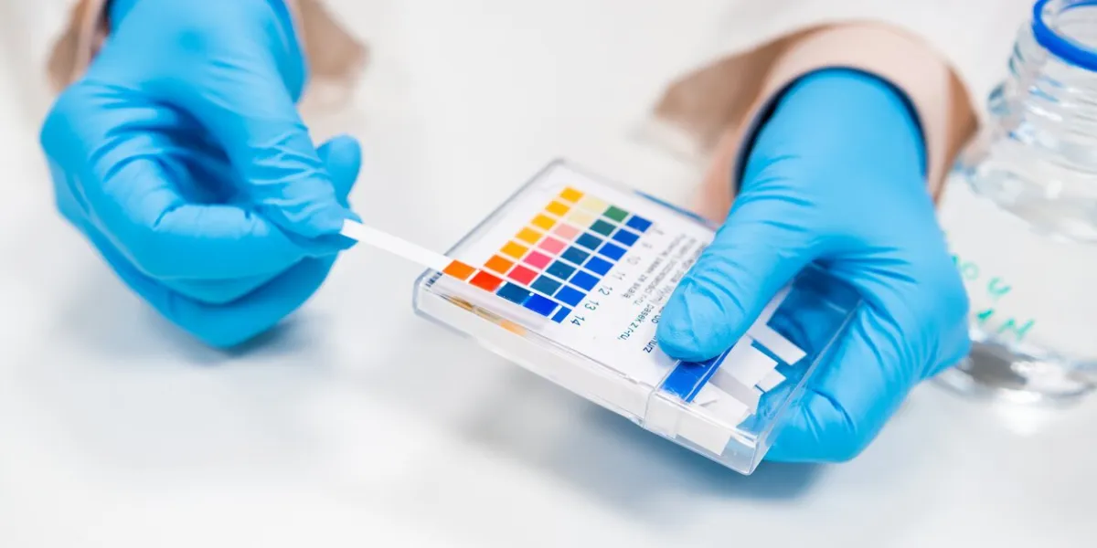 close up scientist test checks a ph using indicator paper