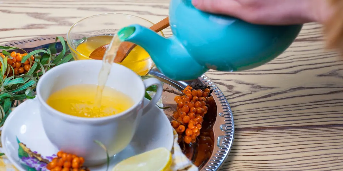 tea made from sea buckthorn berries healthy for health delicious, saturated with vitamins surrounded by berries and sea buckthorn leaves for family tea drinking and maintaining health in the body