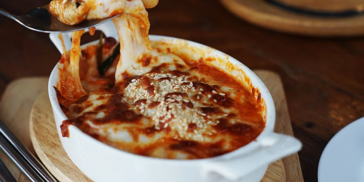 melting cheese on gratin, pasta bake with wheat, cheese and tomato paste yummy dish but high calories copy space