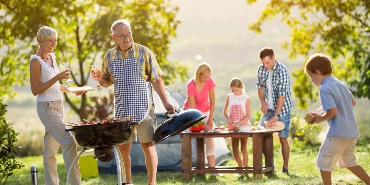 happy family camping and cooking bbq