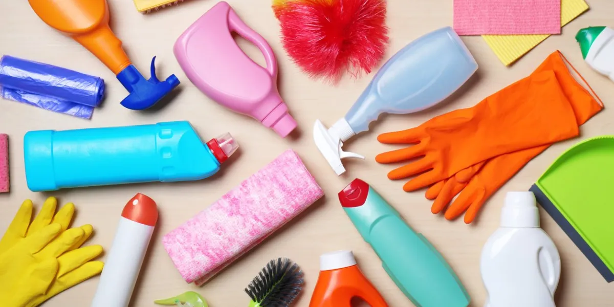 flat lay composition with cleaning supplies on wooden background