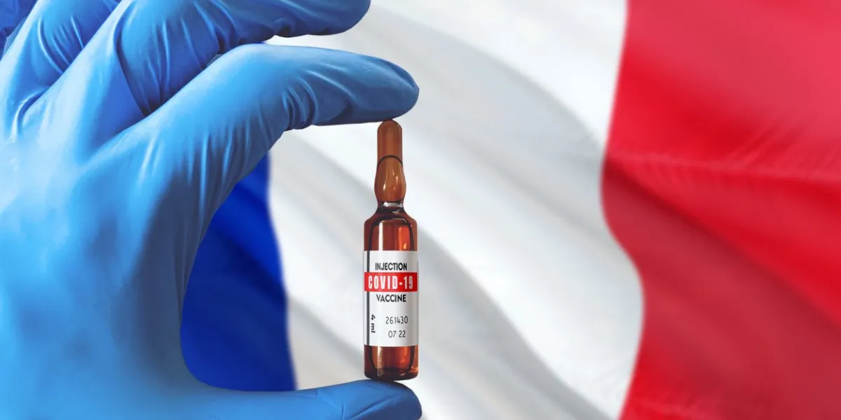 france flag with coronavirus covid-19 concept doctor with blue protection medical gloves holding a vaccine bottle epidemic virus, cov-19, corona virus outbreaking