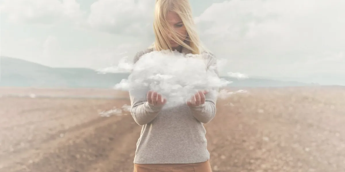 surreal moment , woman holding in her hands a soft cloud
