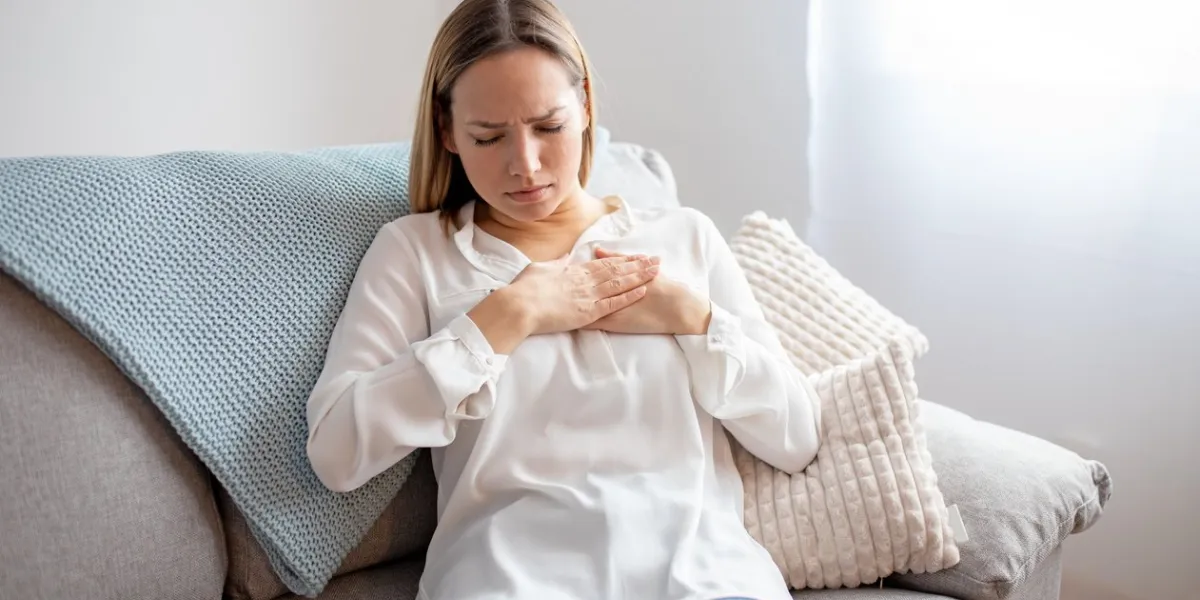 woman having chest pain respiratory system diseases girl having a heart attack at home
