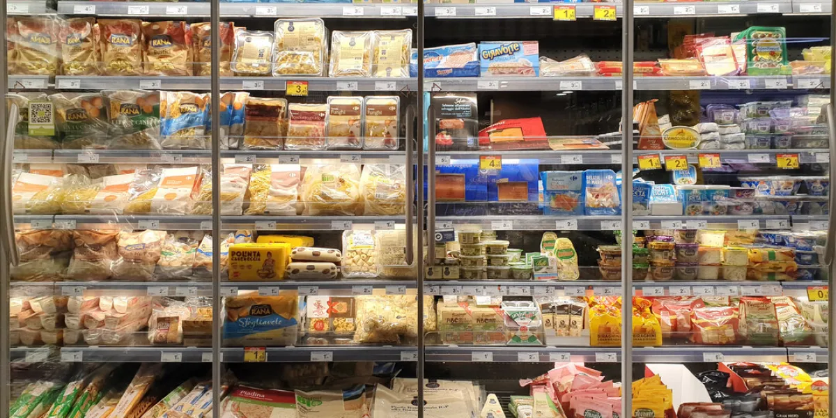 interior view of huge glass freezer with various brand processed