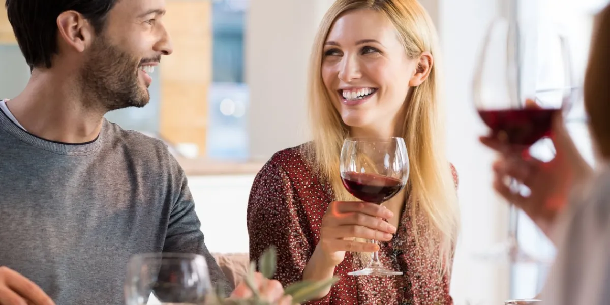 portrait of a happy friends reunion young couples enjoying wine and drinks couple enjoying lunch with family at home