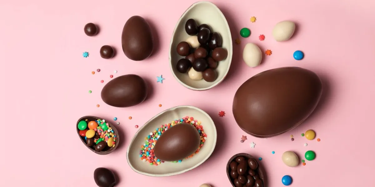 flat lay composition with chocolate easter eggs on color background