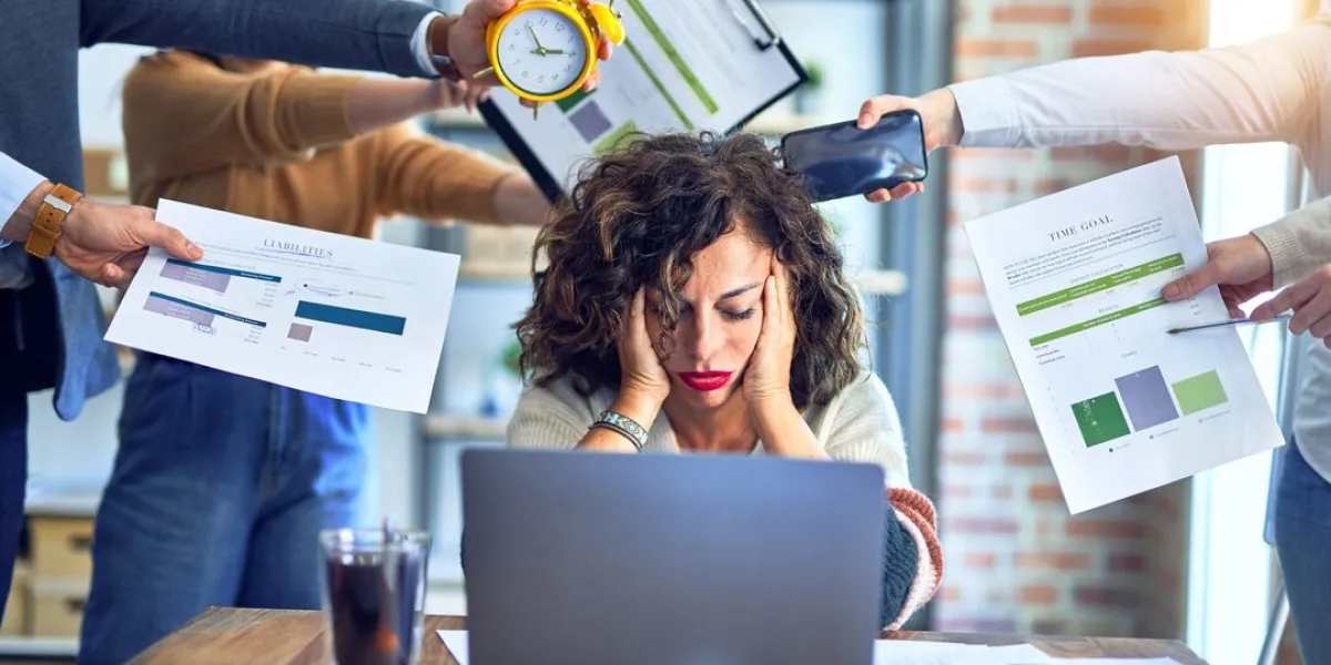 group of business workers working together partners stressing one of them at the office