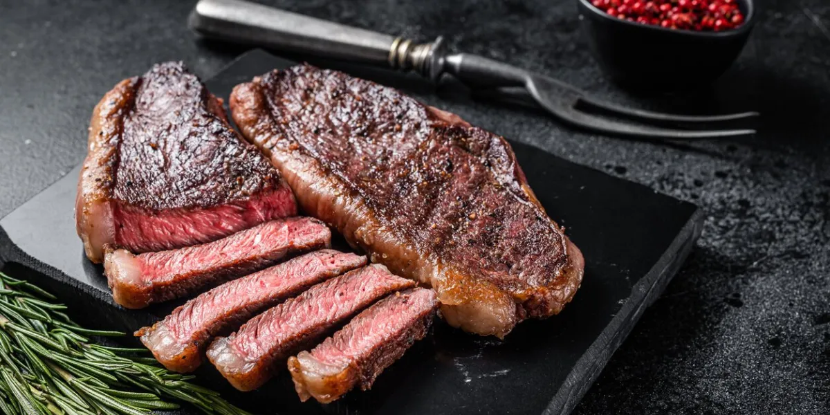 grilled top sirloin or cup rump beef meat steak on marble board black background top view
