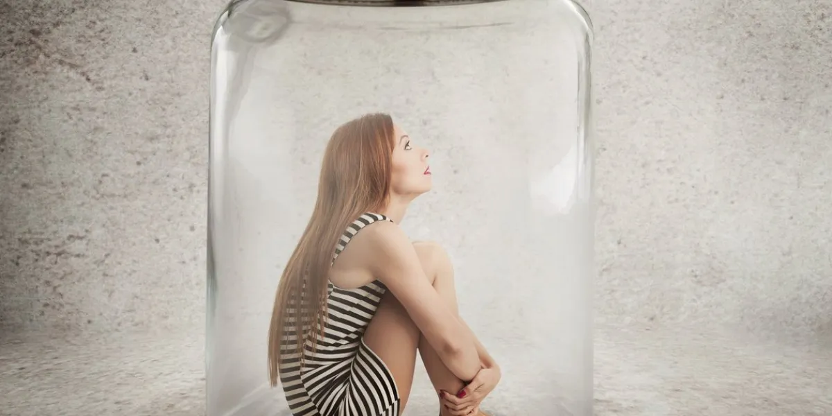 lack, violation of human rights liberty young lonely woman sitting in glass jar isolated grey wall background suppression of freedom, restrain, employee working conditions, life limitation concept
