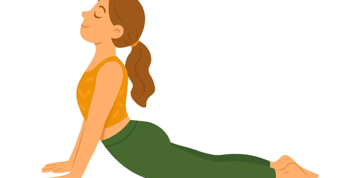 young woman practicing cobra yoga pose with calm expression, wearing orange top and green pants