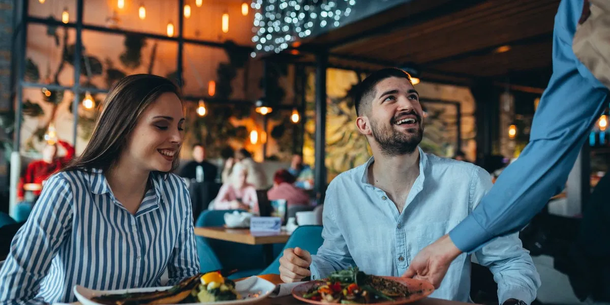 romantic couple in restaurant having lunch