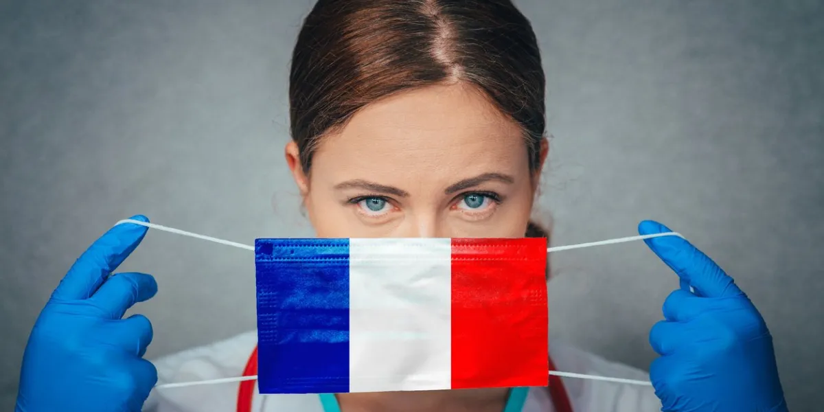 coronavirus in france female doctor portrait hold protect face surgical medical mask with france national flag illness, virus covid-19 in france, concept photo
