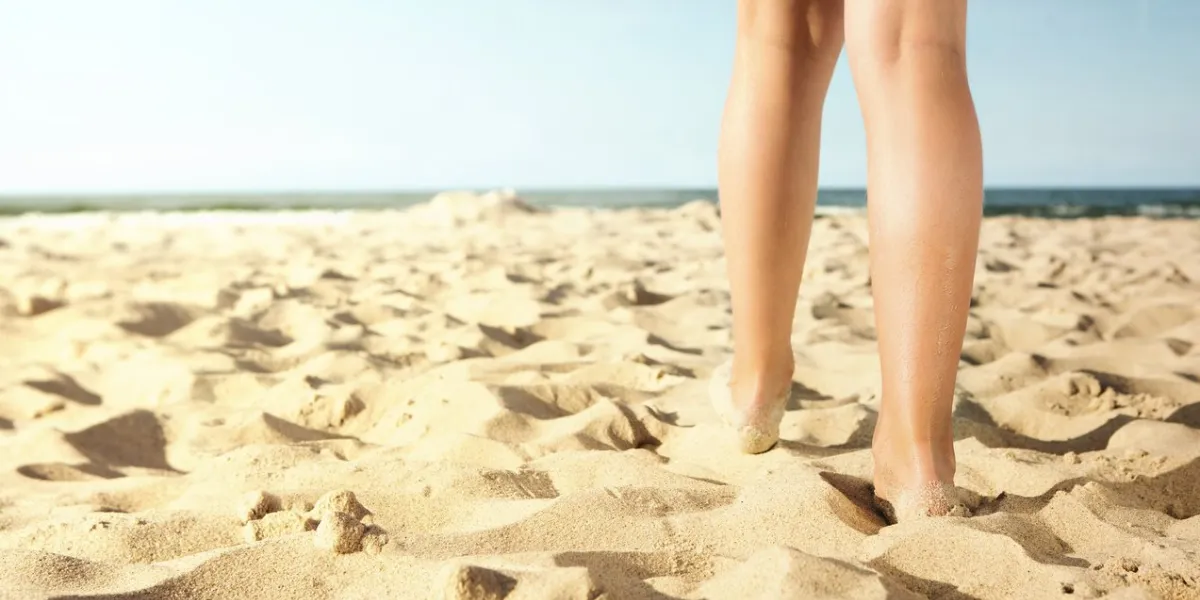 close up of little girl walking on the beach with copy space