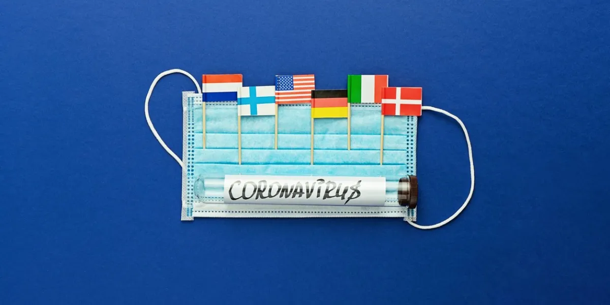 protective surgical mask and flags of countries that have confirmed cases of coronavirus concept of global spread of coronavirus novel 2019-ncov virus