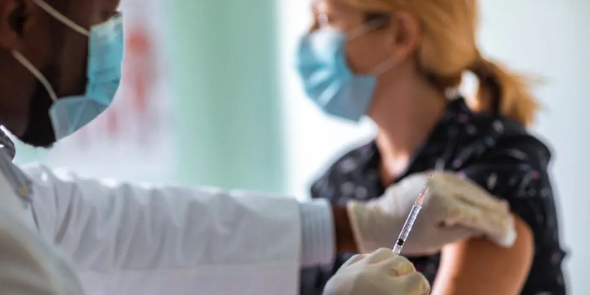 close up of a young woman getting vaccinated