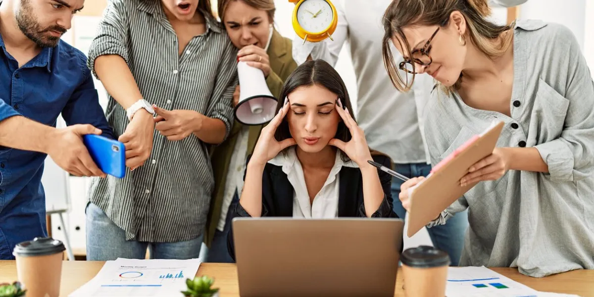 group of business workers screaming to stressed partner at the office