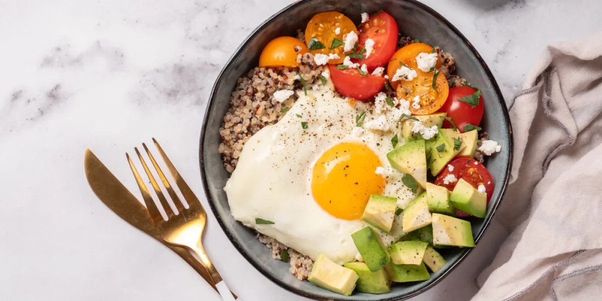 keto diet plate quinoa, avocado, egg and tomatoes healthy food, ketogenic diet