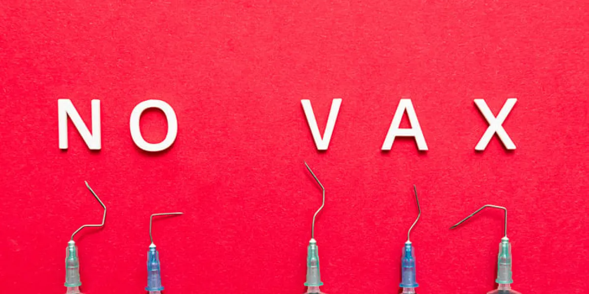 the phrase no vax, broken injection syringes on a red background stop vaccination concept coronavirus anti vax controversy concept