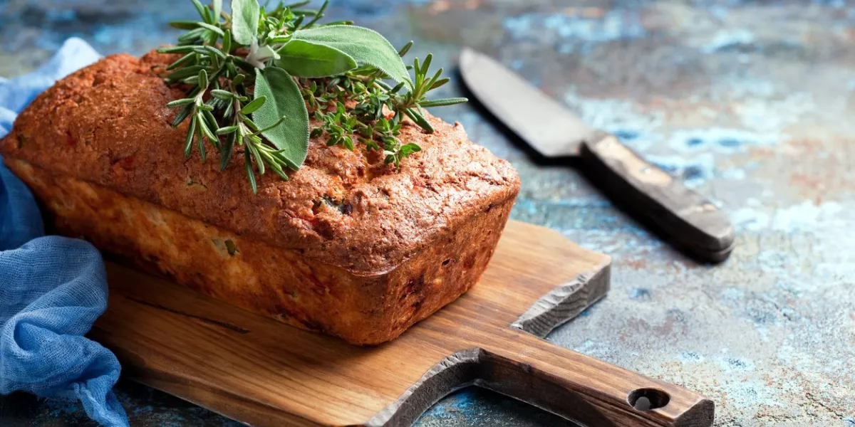 savoury loaf cake with cheese, peppers and chicken ham, selective focus