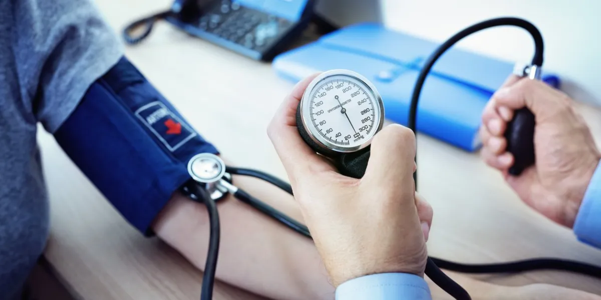 doctor checking the blood pressure of a patient