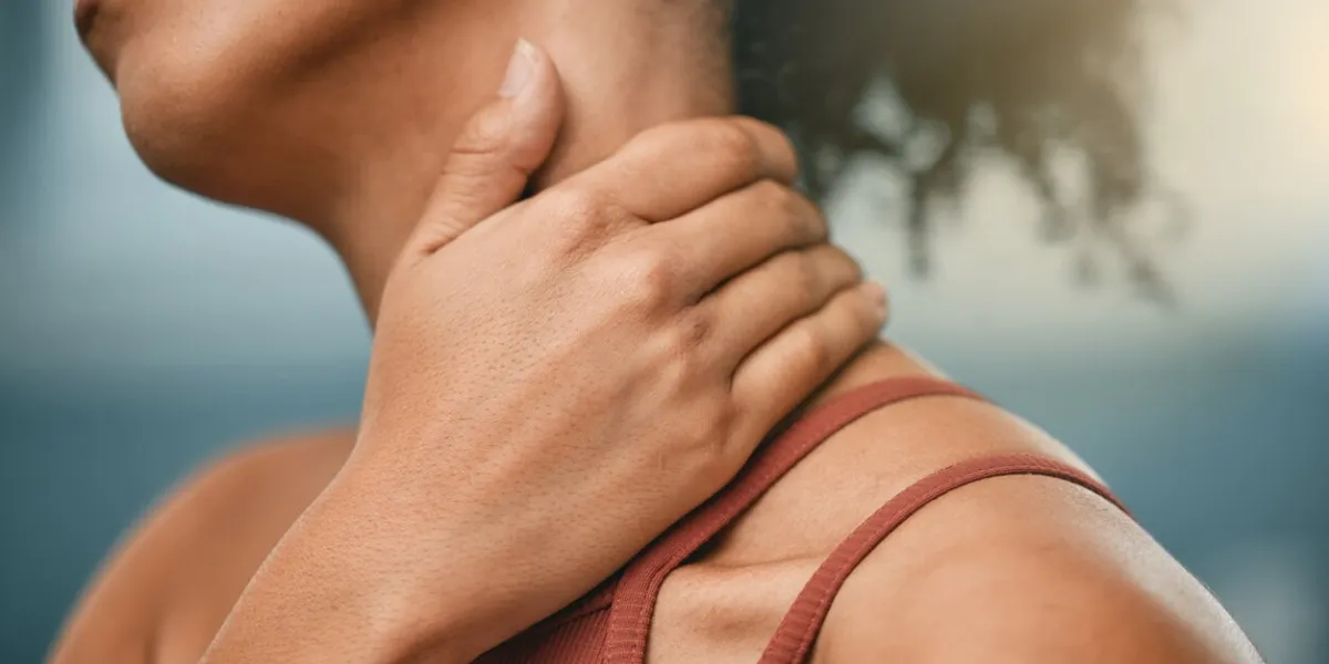 fitness, injury and woman with neck pain from sports after gym accident, emergency and muscle trauma inflammation, sore and hand of an athlete with a painful body after training, exercise and cardio