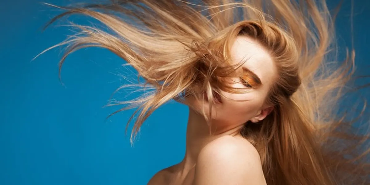 beautiful woman with long brown hair on a blue background