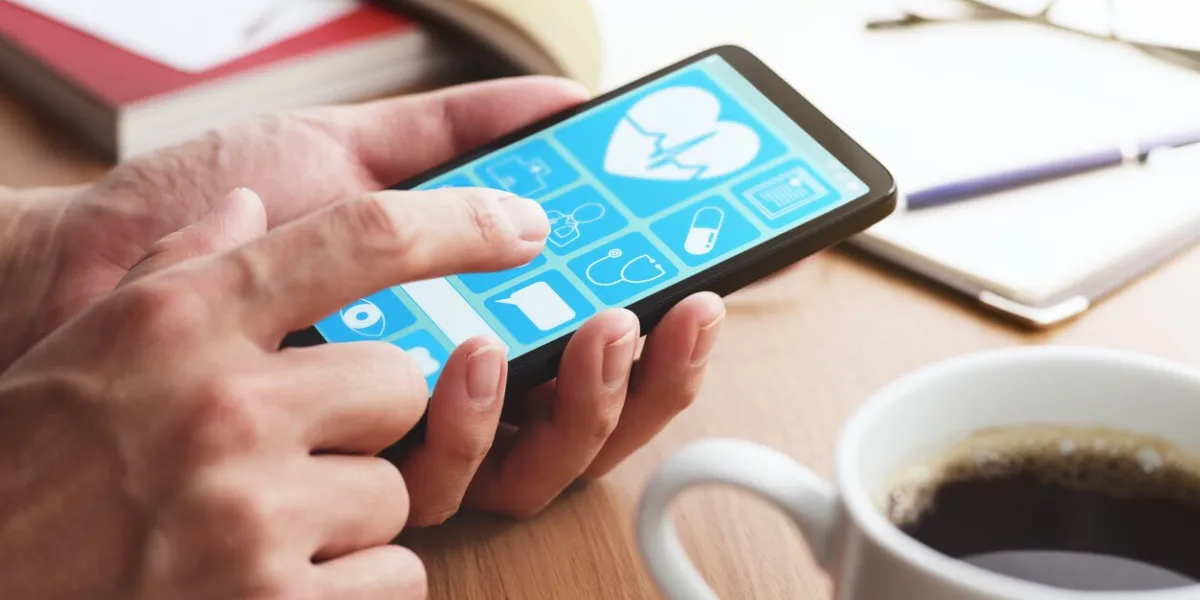 closeup of male hands touching smartphone screen at table