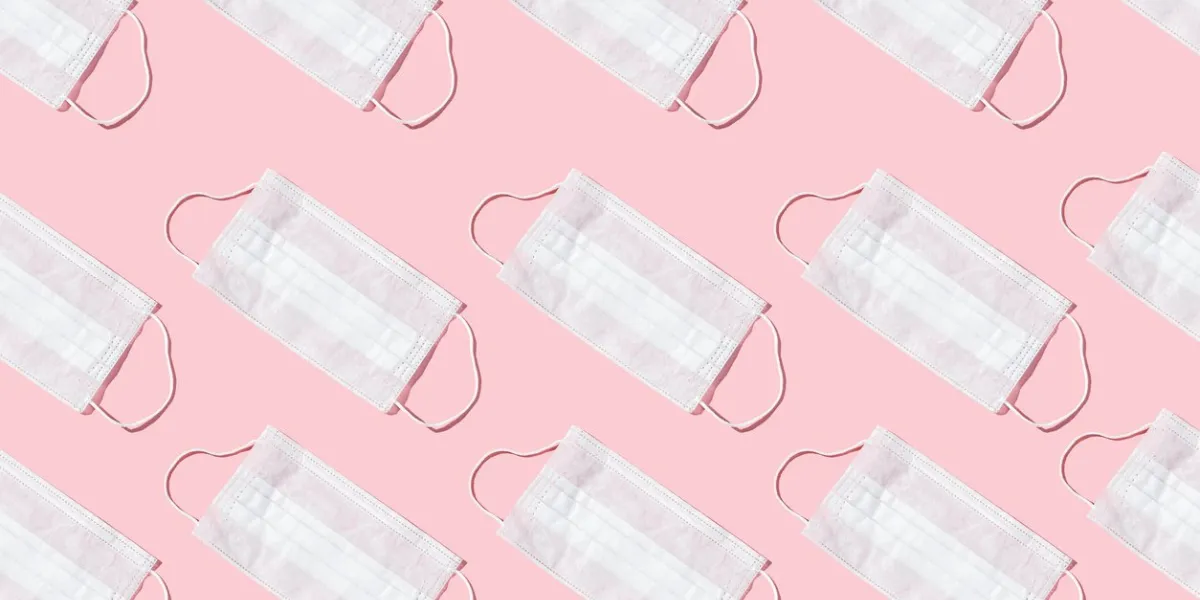 many medical masks on the pink colored background to cover the mouth and nose for protection from virus and bacteria on a pink background epidemic concept regular pattern, flat lay