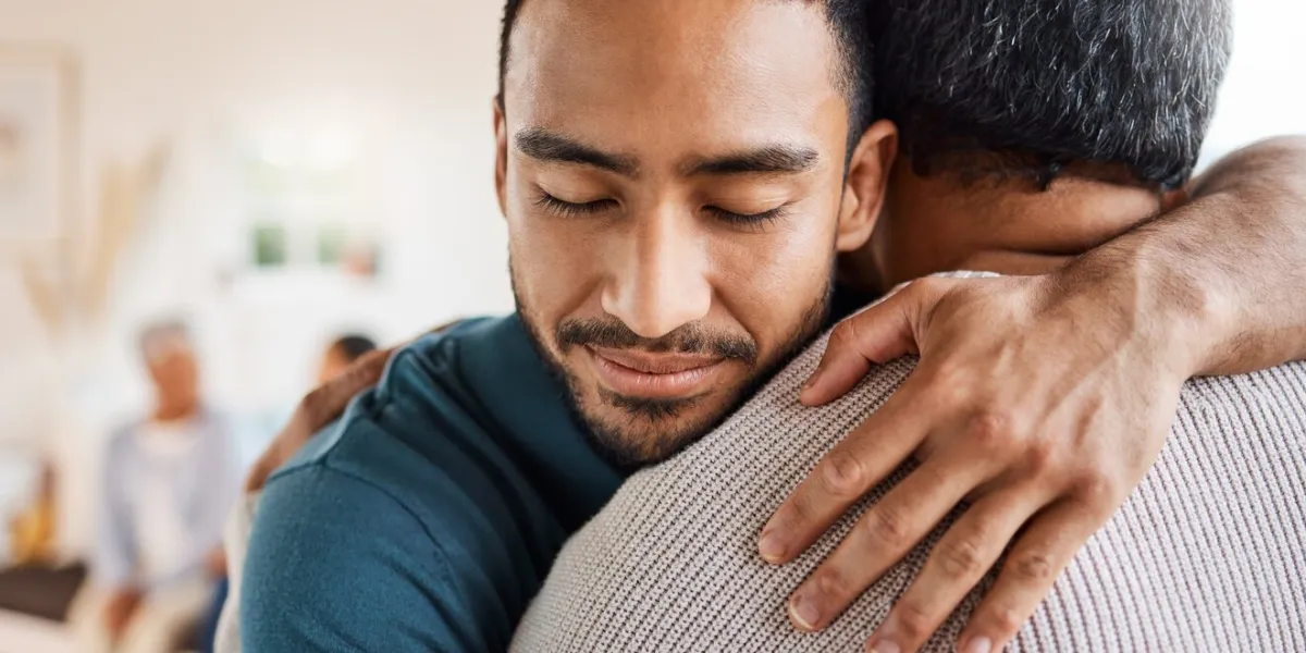 shot of a father and son hugging at home