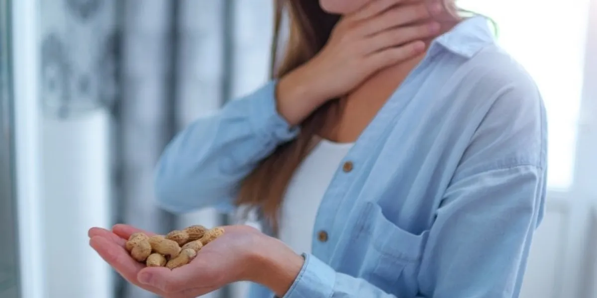 young woman suffers from choking and cough from allergic reaction to peanut danger of nuts and food allergy