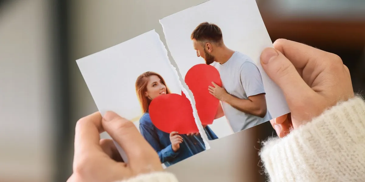 woman tearing up photo of happy couple, closeup concept of divorce