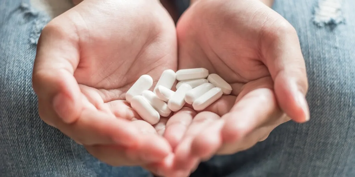 teenager girl having pharmaceutical medical pills for pain relief or antibiotic healthcare medication healing from illness