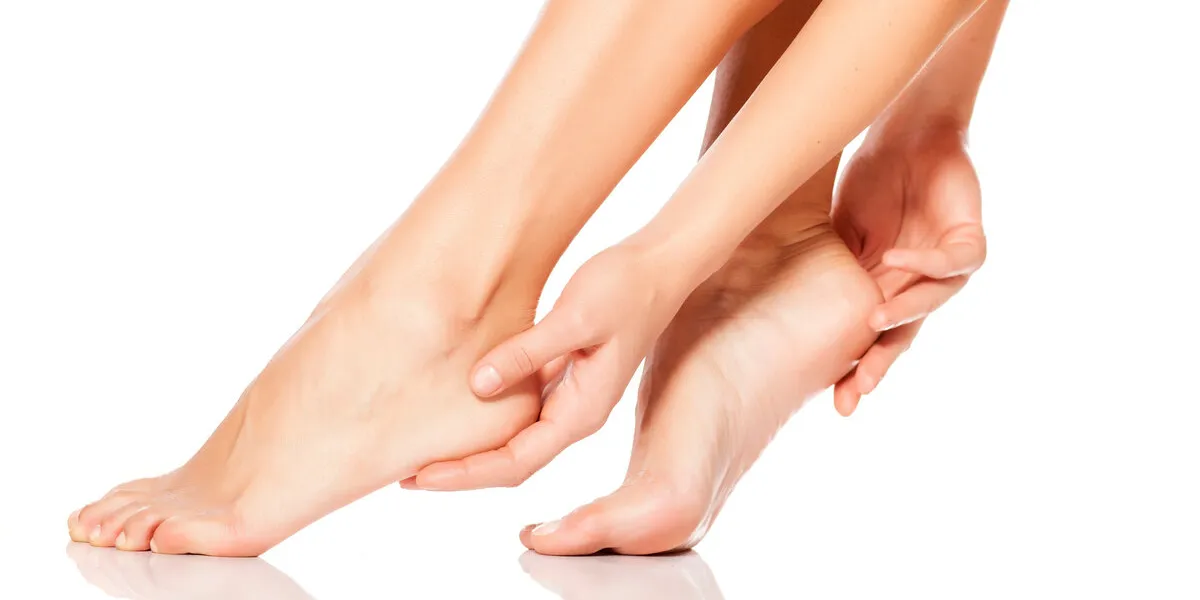 woman tenderly touching her feet