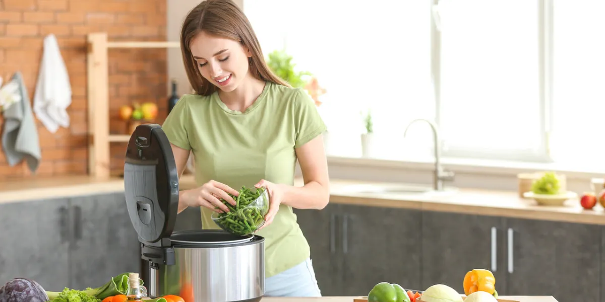 woman using modern multi cooker in kitchen