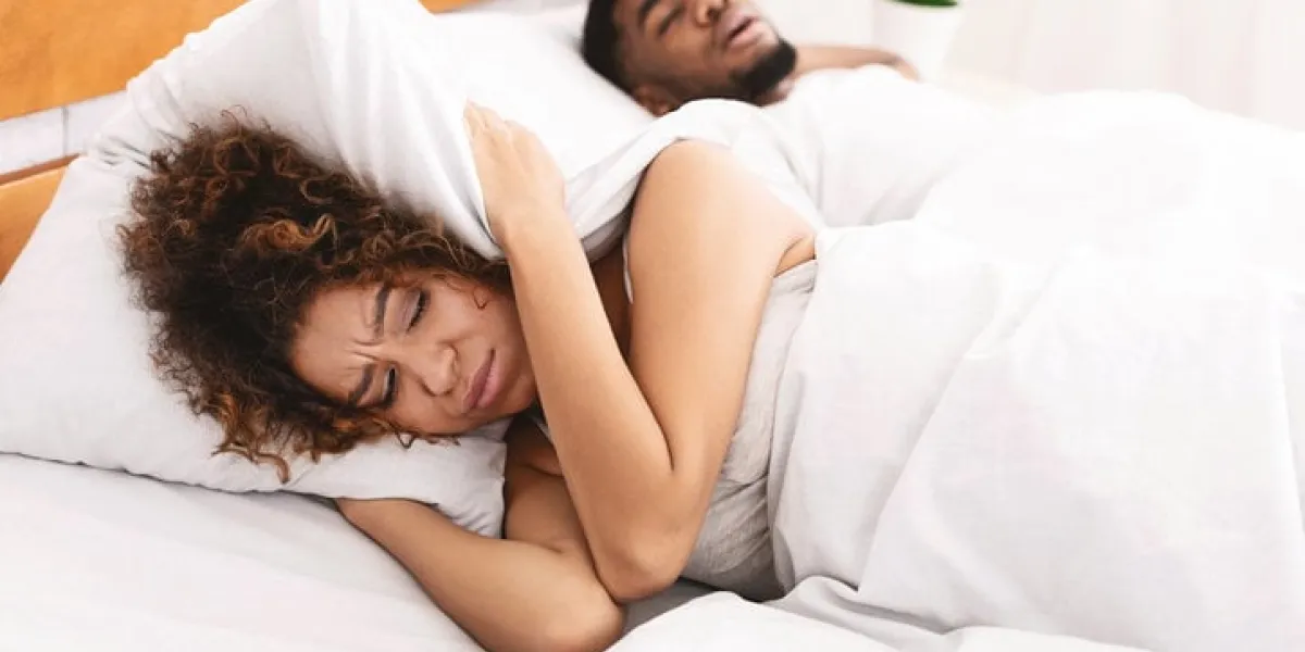 snoring man is annoying young african-american woman suffering from her noisy sleeping boyfriend