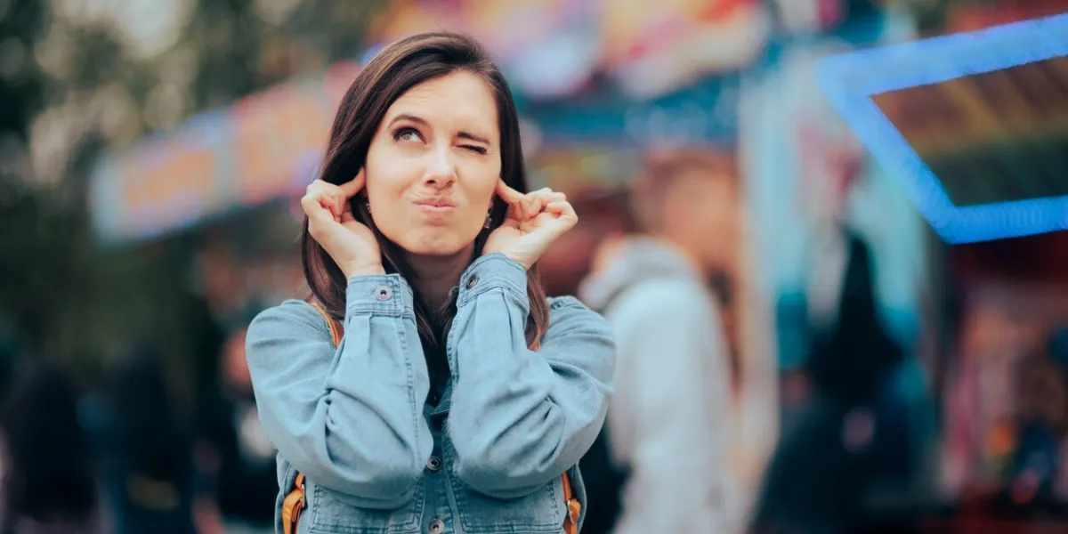 stressed woman frustrated and annoyed with the unbearable noise