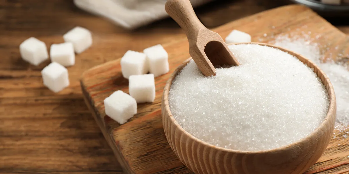 granulated sugar in bowl on wooden table