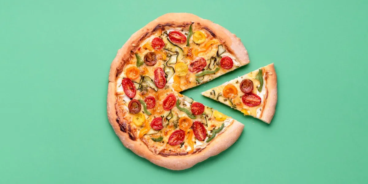 vegetarian pizza on a green background pizza primavera and just one slice single slice of spring pizza italian meal cherry tomato pizza