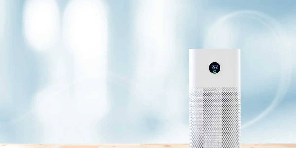 air purifier a living room, air cleaner removing fine dust in house protect pm 25 dust and air pollution concept