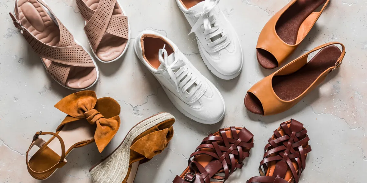 variety of summer women's shoes - sneakers, sandals, roman sandals, slippers on a light background, top view