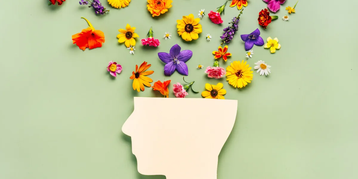 human head symbol and flowers on blue background world mental health day concept