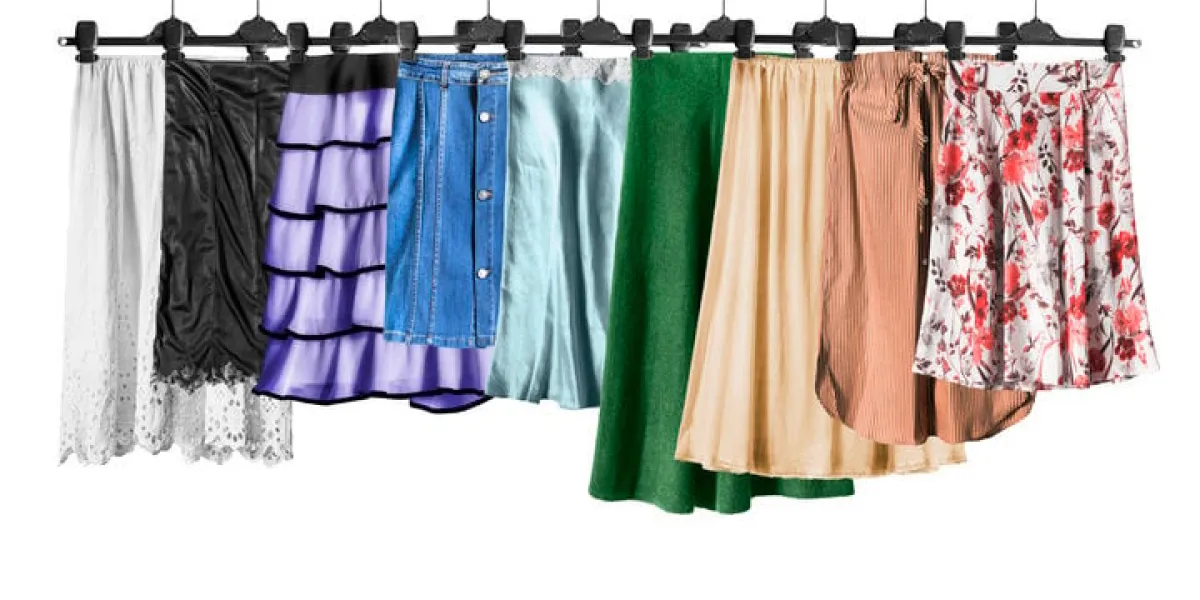 set of colorful skirts on clothes racks isolated over white