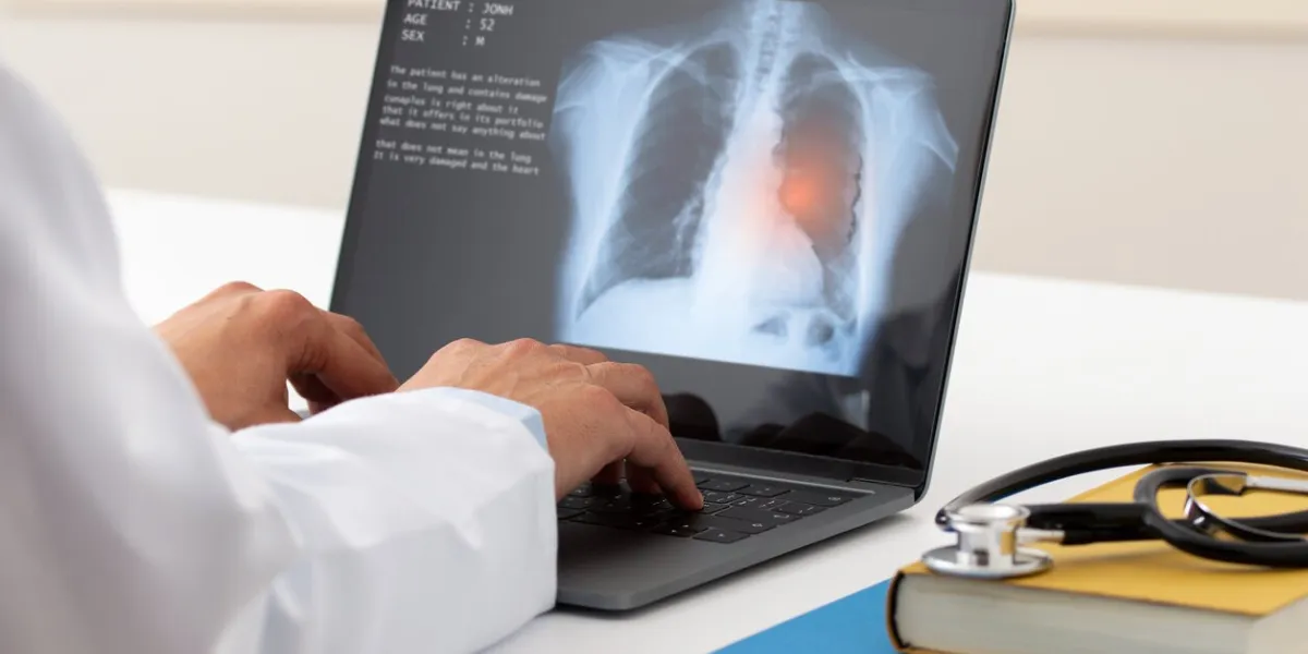a pulmonologist working with laptop at office health care concept